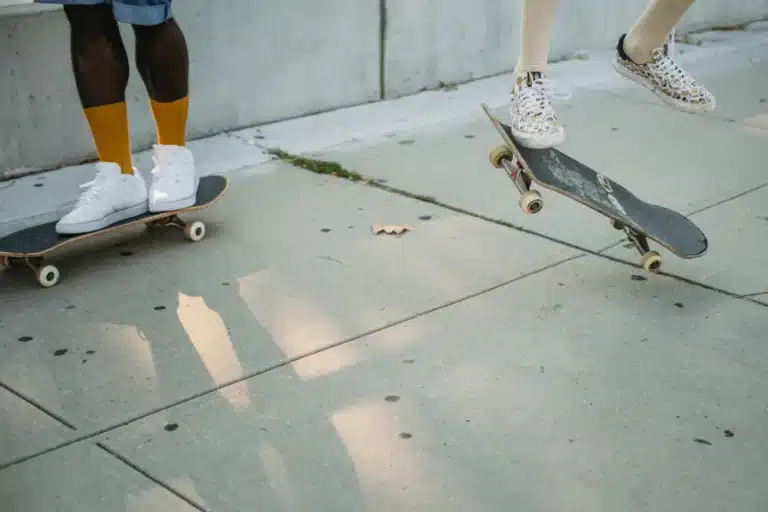 Skaters riding skateboard and practicing trick on street